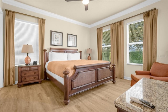 bedroom with ceiling fan, crown molding, light hardwood / wood-style flooring, and multiple windows