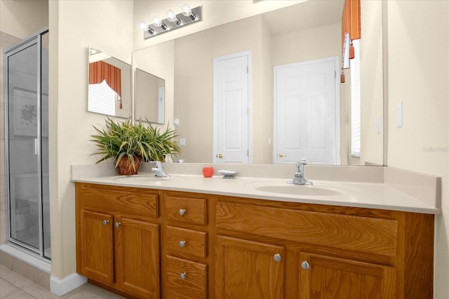 bathroom featuring tile patterned flooring, vanity, and a shower with shower door