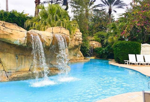 view of swimming pool featuring pool water feature