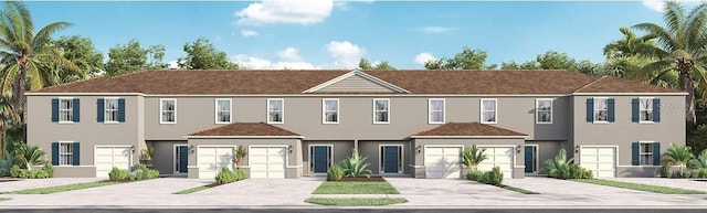 view of front of house with driveway, an attached garage, and stucco siding