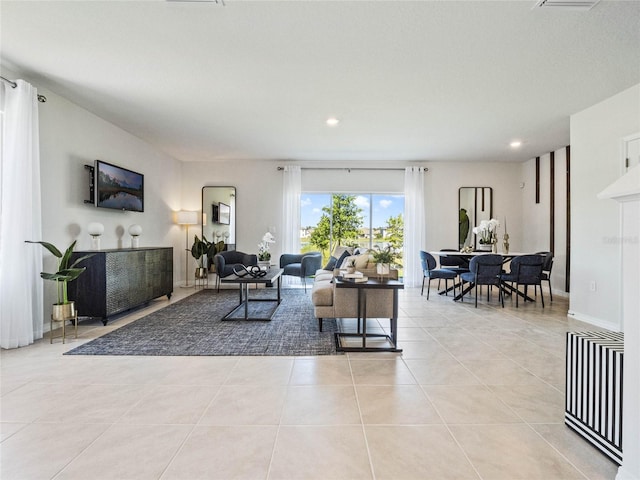 living area featuring light tile patterned floors, baseboards, and recessed lighting