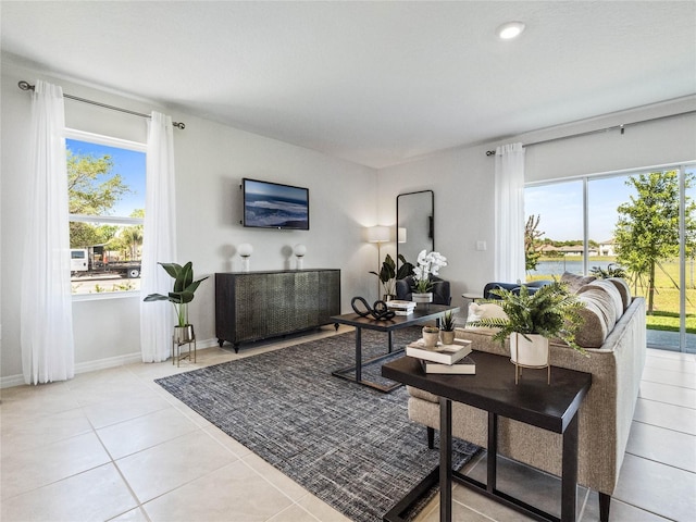 living area with light tile patterned floors and baseboards