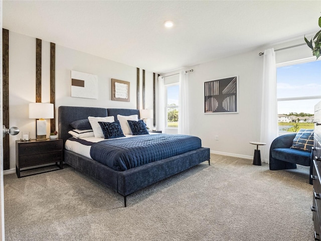 bedroom with light carpet and baseboards