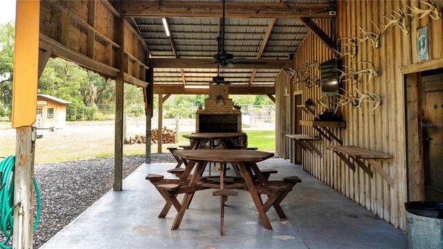 view of patio / terrace featuring a fireplace and ceiling fan