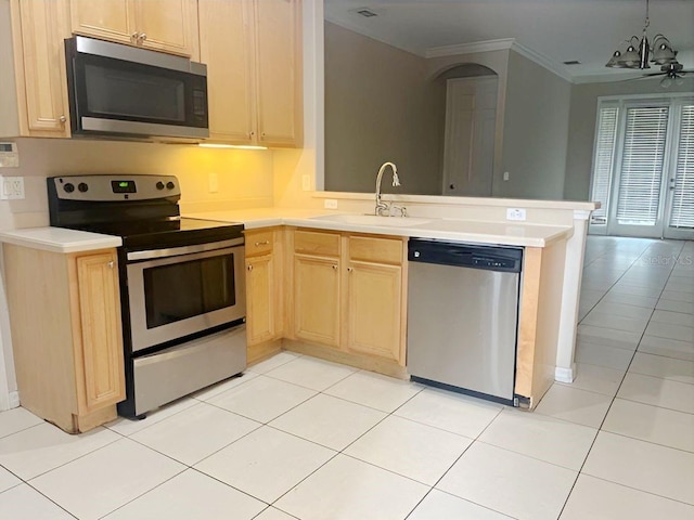 kitchen featuring sink, light tile patterned floors, light brown cabinetry, kitchen peninsula, and stainless steel appliances