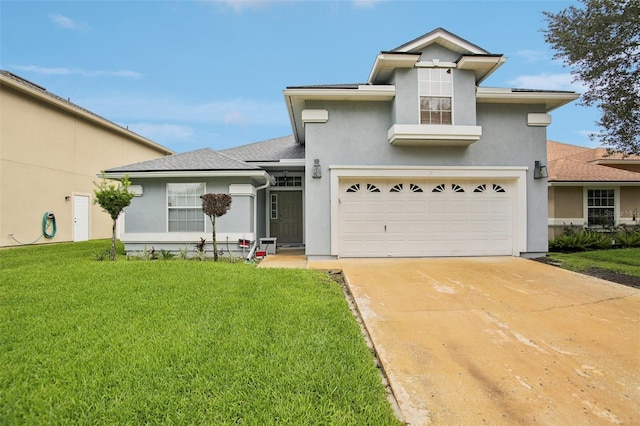 view of front of property with a front lawn and a garage