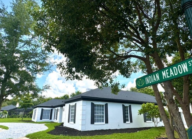 view of side of property with a lawn