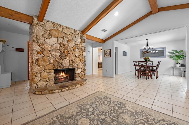 tiled living room with vaulted ceiling with beams, visible vents, a stone fireplace, a textured ceiling, and a chandelier