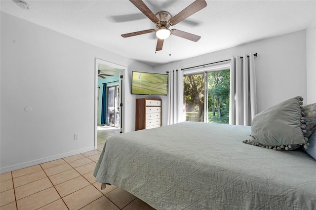 tiled bedroom featuring ceiling fan