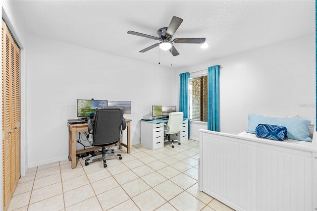 tiled office featuring a textured ceiling and ceiling fan