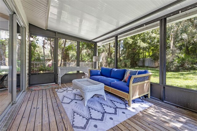 sunroom / solarium featuring vaulted ceiling and a wealth of natural light