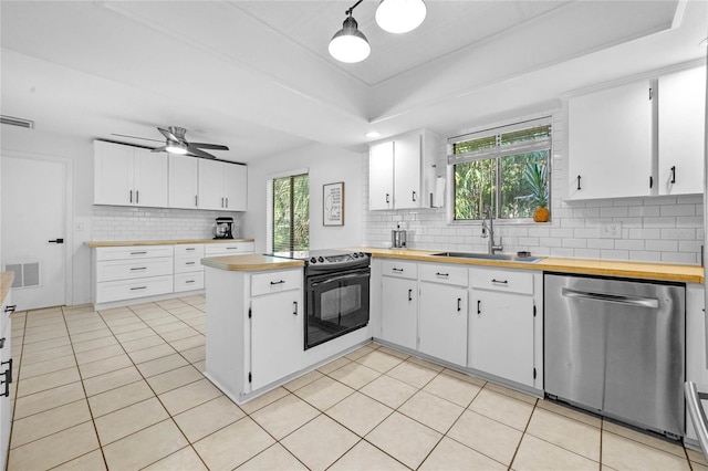 kitchen with a peninsula, electric range, a sink, visible vents, and stainless steel dishwasher