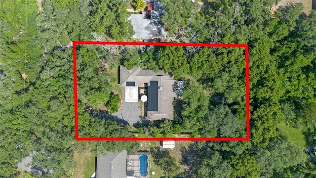 birds eye view of property with a forest view