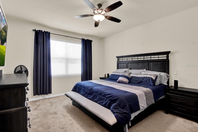 carpeted bedroom with a textured ceiling and ceiling fan