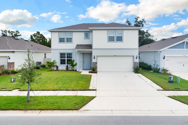 view of property featuring a garage and a front yard