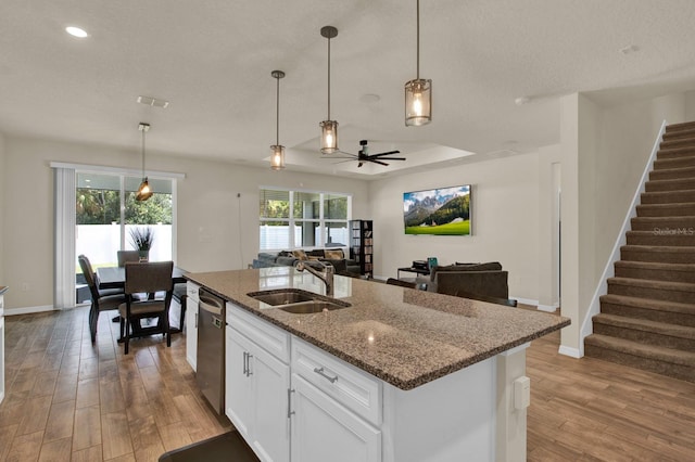 kitchen featuring ceiling fan, sink, light hardwood / wood-style flooring, dishwasher, and white cabinetry