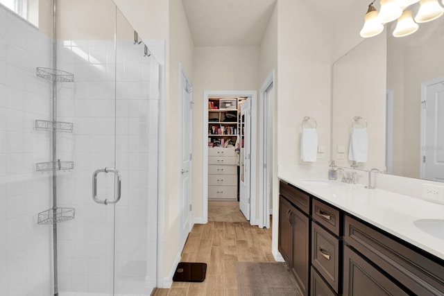 bathroom featuring vanity, hardwood / wood-style flooring, and a shower with door