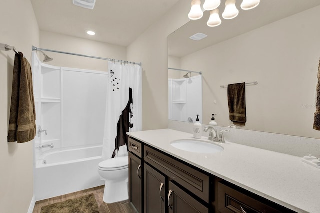 full bathroom featuring hardwood / wood-style floors, vanity, toilet, and shower / tub combo with curtain