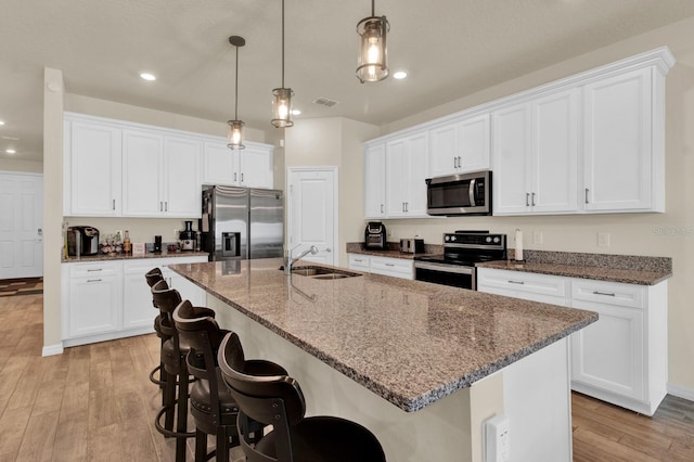 kitchen with white cabinets and appliances with stainless steel finishes