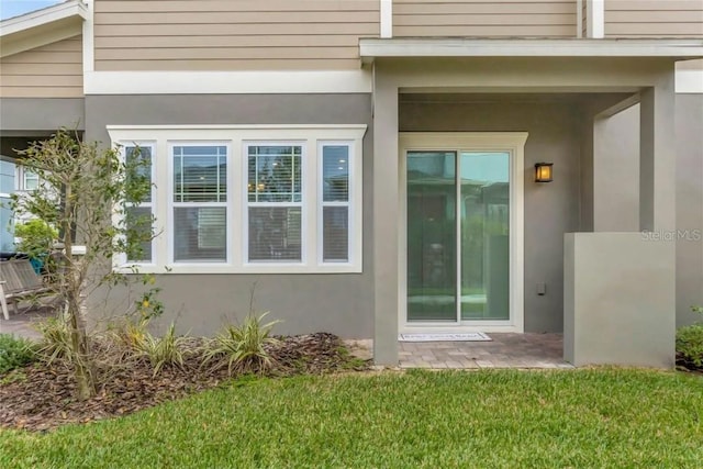 doorway to property with a yard