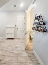 corridor with light wood-type flooring