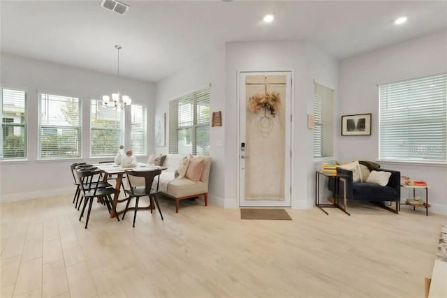 dining space featuring an inviting chandelier and light hardwood / wood-style floors