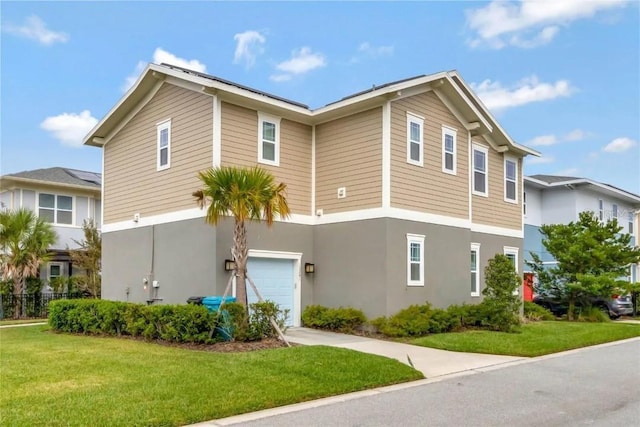 view of front facade featuring a garage and a front lawn