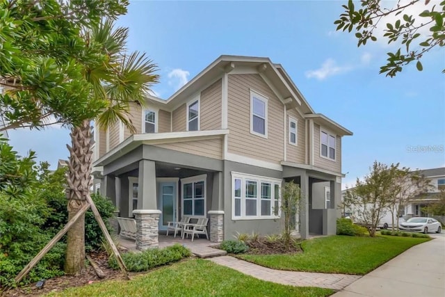 exterior space featuring a front lawn and a porch