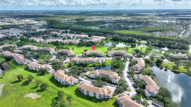 drone / aerial view with a residential view and a water view