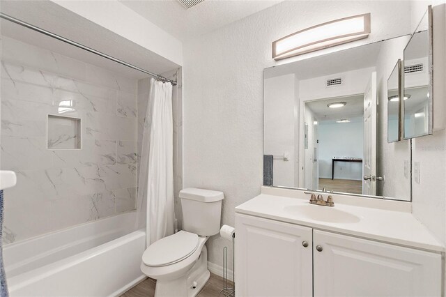 full bathroom with a textured ceiling, vanity, wood-type flooring, toilet, and shower / bathtub combination with curtain