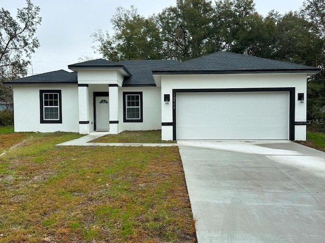 view of front facade with a garage and a front yard