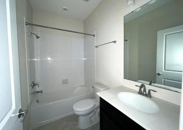 full bathroom with toilet, tiled shower / bath, and vanity