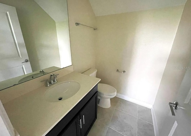 bathroom featuring toilet, vanity, and tile patterned floors