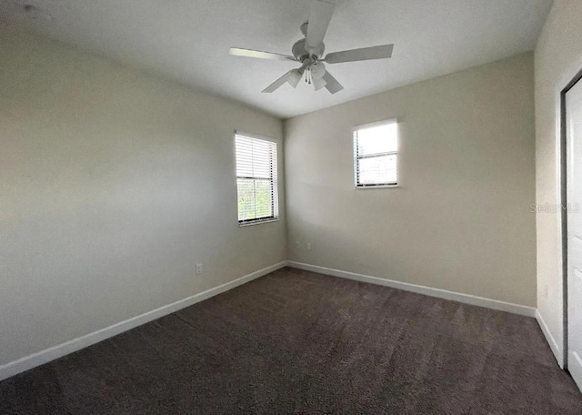 carpeted spare room with ceiling fan