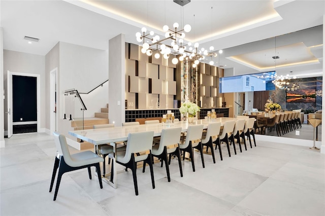 dining space featuring a chandelier and a tray ceiling