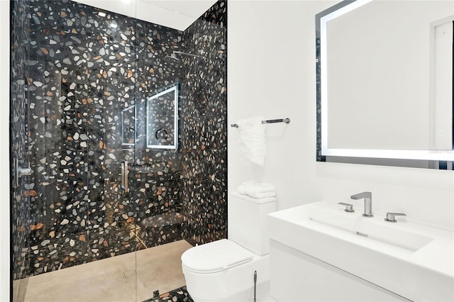 bathroom featuring tile patterned floors, vanity, toilet, and walk in shower