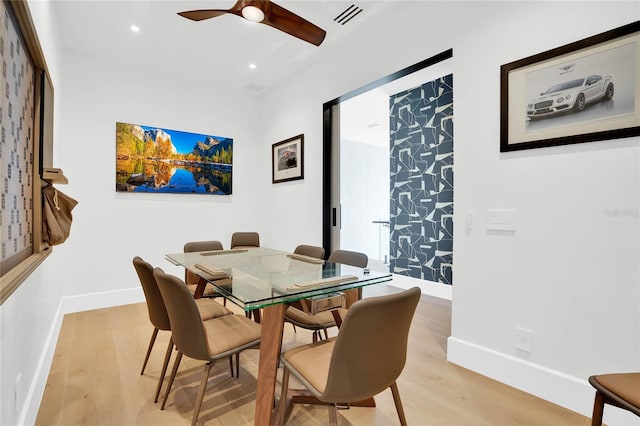 dining space featuring ceiling fan and light wood-type flooring