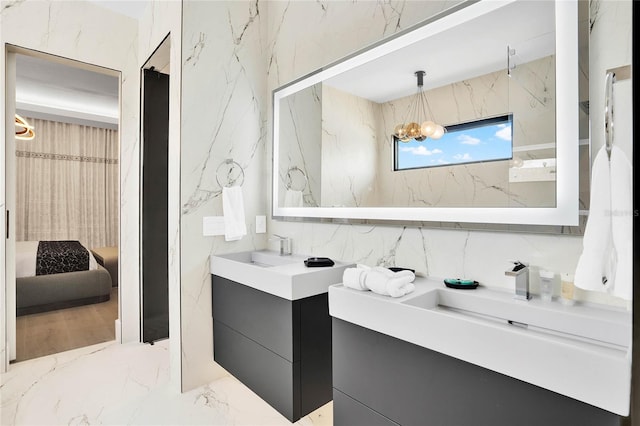 bathroom featuring a chandelier and vanity