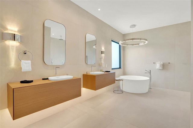 bathroom featuring tile patterned flooring, vanity, and a bathtub