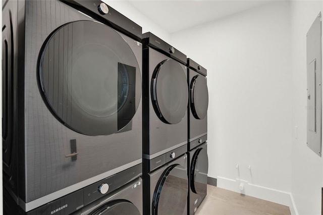 laundry room with stacked washer and dryer and electric panel