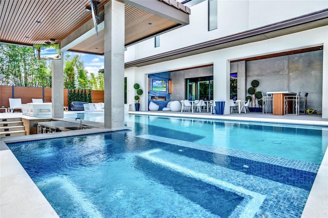 view of pool featuring an outdoor bar and exterior kitchen