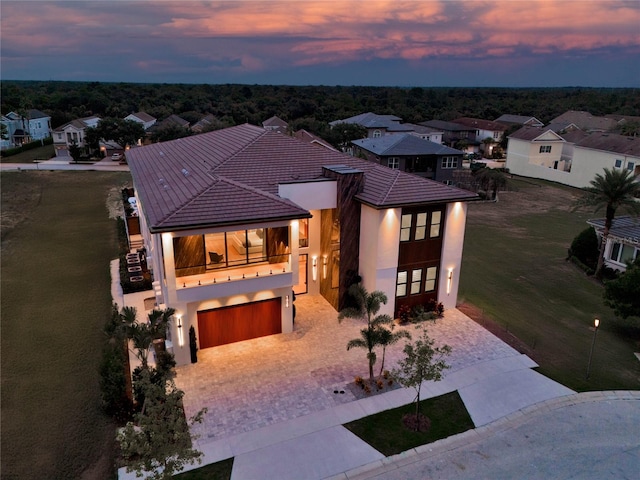 view of front of property featuring a garage and a balcony