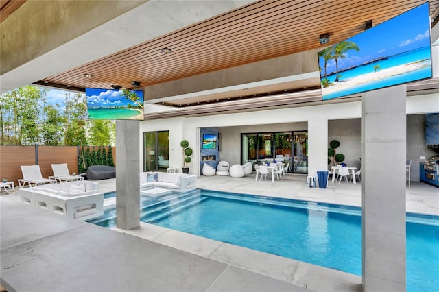 view of swimming pool featuring a patio area and a jacuzzi