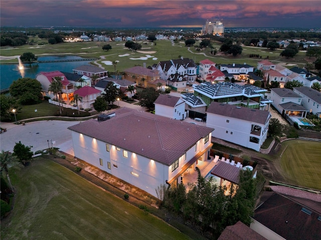 aerial view at dusk with a water view