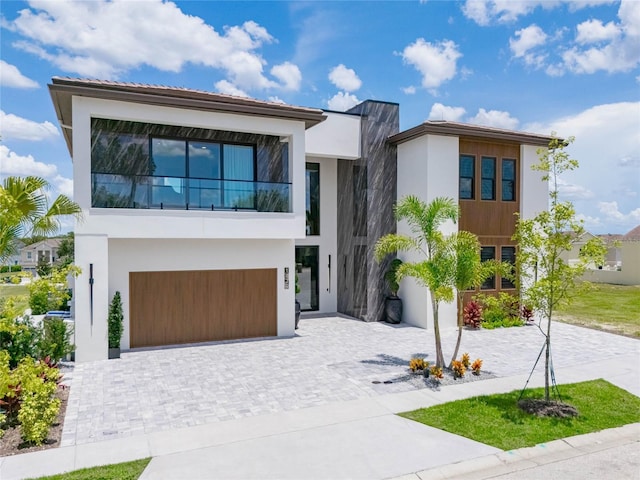 modern home featuring a balcony and a garage