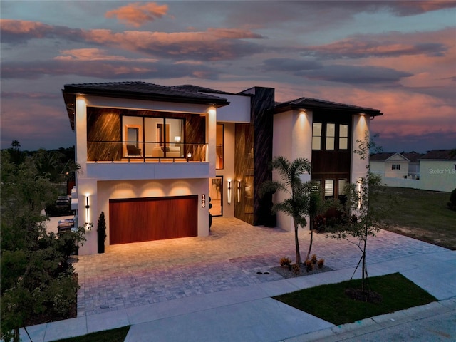 view of front of property with a balcony and a garage