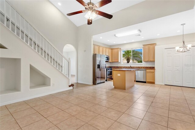 kitchen featuring light brown cabinetry, ceiling fan, light tile patterned floors, and appliances with stainless steel finishes