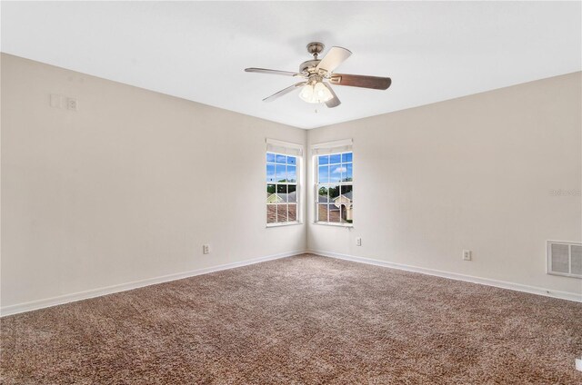 carpeted spare room with ceiling fan