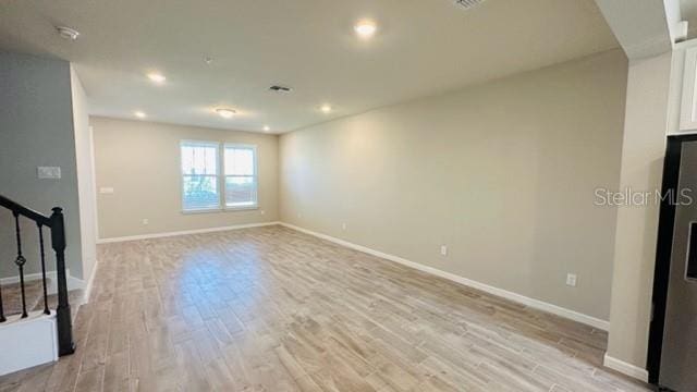 unfurnished living room featuring light hardwood / wood-style floors