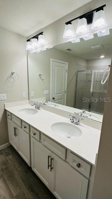 bathroom featuring vanity, a shower with shower door, and hardwood / wood-style flooring